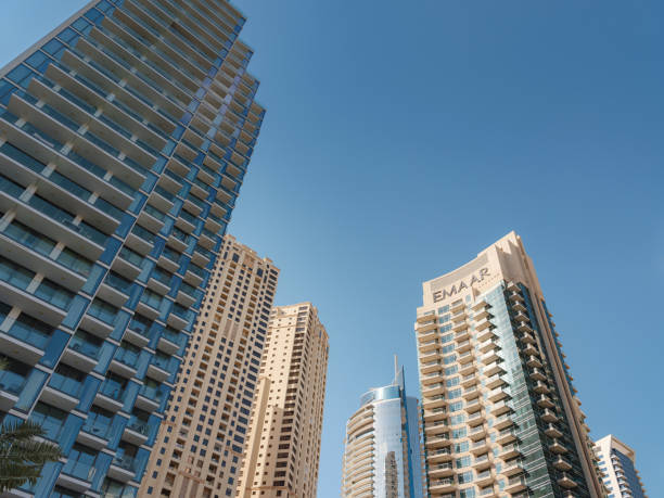 Skyscrapers in Dubai showcase modern real estate development under a clear blue sky.